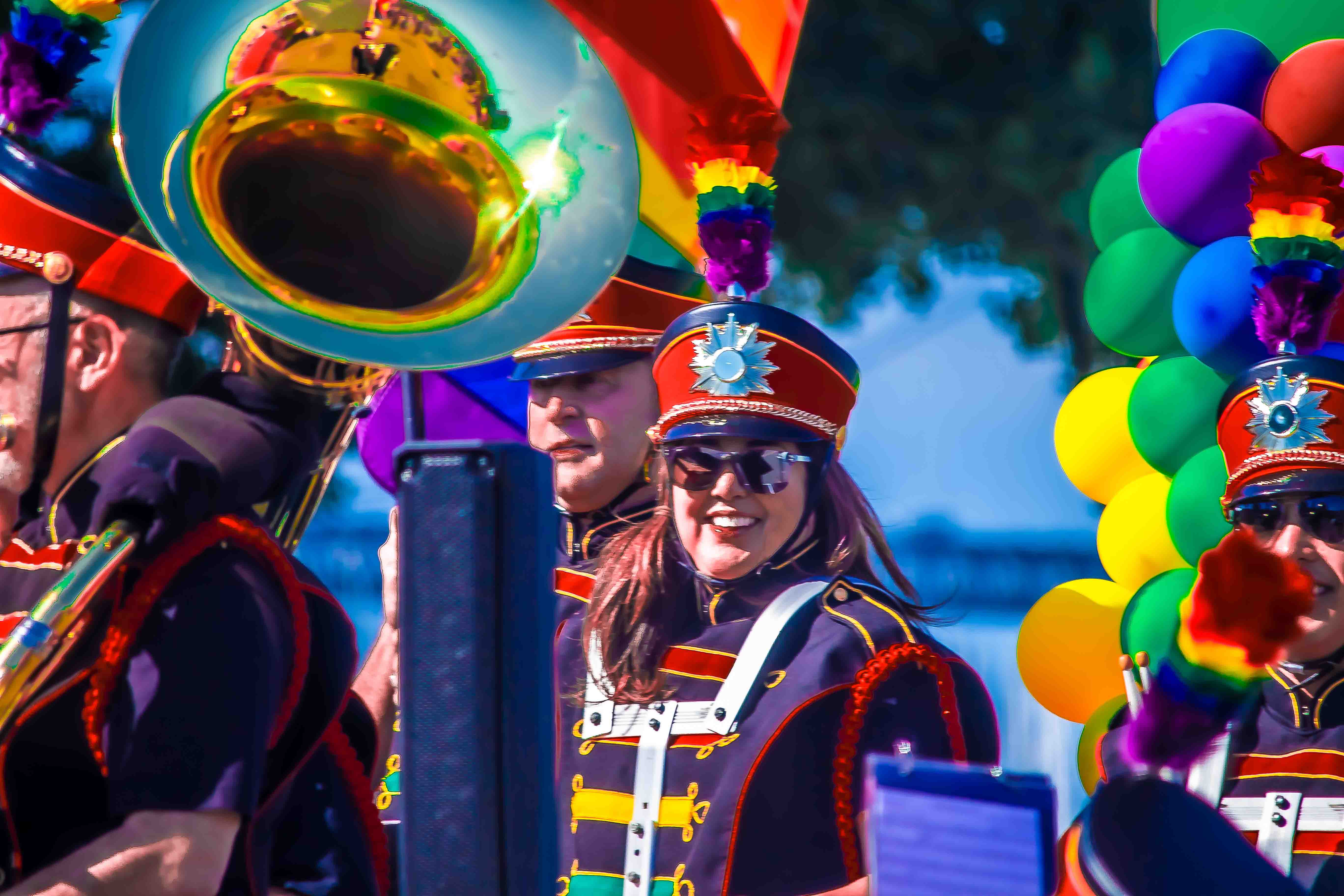 Oracle Park pregame — Freedom Band in rainbow-feathered marching hats